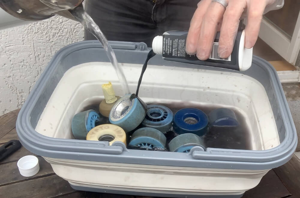 Pouring dye and hot water over roller skate wheels